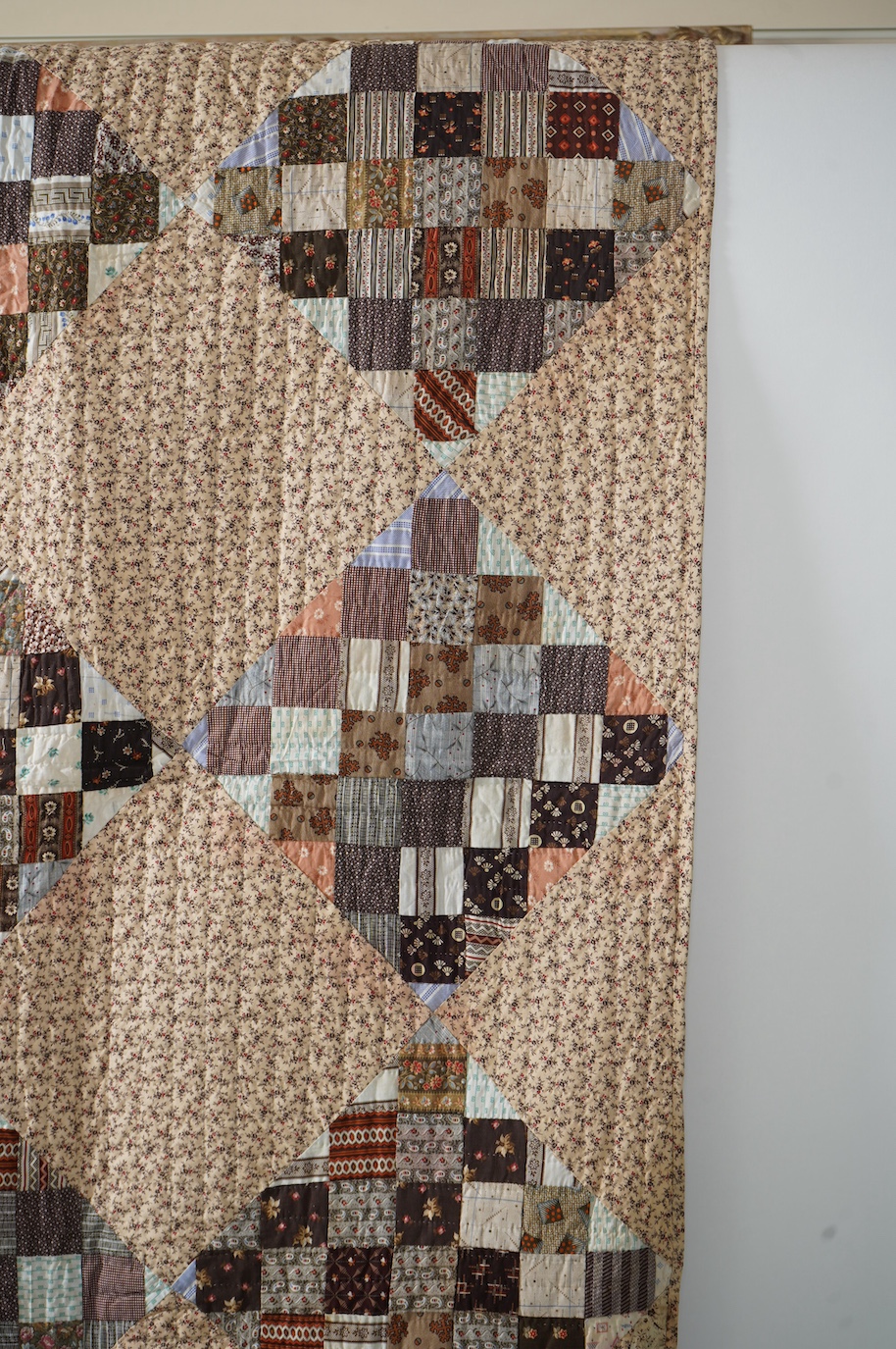 An American Kentucky 1865 (Civil War) block strip, ‘postage stamp’ hand quilted bedcover. Made from a large selection of highly fashionable madder dyed printed cottons of the day, as large concentric diamond shaped strip